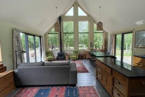 a living room with a couch and some windows at Number 8 - Castle Hill Village in Castle Hill