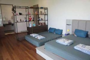a living room with two beds and a shelf at Tranquil lake view retreat 思湖茶屋 in Ipoh