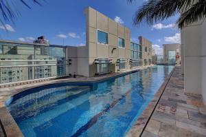 a large swimming pool in front of a building at LFlats Hotel Oscar Freire in São Paulo