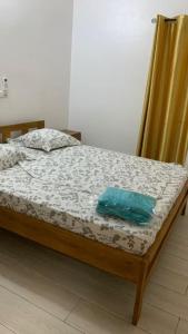 a bed with a wooden frame and a curtain at Résidence Étoile in Cotonou