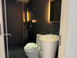 a bathroom with a toilet and a sink and a shower at Beat Hotel Bangkok in Bangkok +37 photos