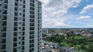 a view of a city from a tall building at Cozy Living and Homey Studio Room Cinere Resort Apartment By Travelio in Depok