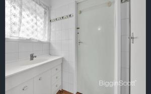a white bathroom with a sink and a shower at Springvale Single Room for Rent in Springvale South
