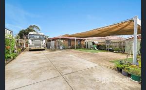 a semi truck parked in a driveway with a canopy at Springvale Single Room for Rent in Springvale South