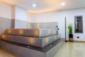 a lobby with a metal staircase in a building at Hotel California City in Medellín