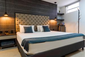 a bedroom with a large bed with a large headboard at Hotel California City in Medellín +73 photos