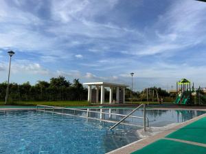 a swimming pool with a slide and a playground at D' Heights Monterrace Lake Condo in Mabalacat