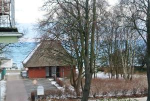 a small red building with a tree in the foreground at Villa Laura 12 in Kühlungsborn