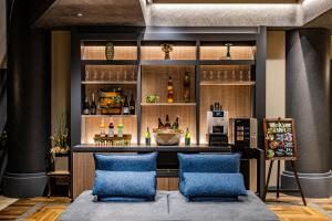 a bar with two blue chairs in front of it at Hotel Quest Shimizu in Shizuoka