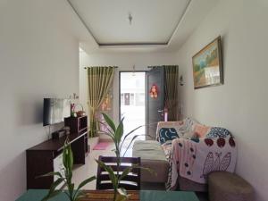 a living room with a couch and a table at Sweet House Homestay Near Mall Pekanbaru Sudirman in Pekanbaru