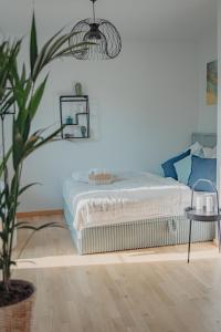 a bedroom with a bed and a potted plant at Neue Wohnung im Zentrum in Dresden