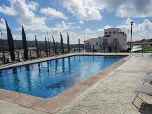 a swimming pool in front of a building at Aztec Penthouse in Ensenada