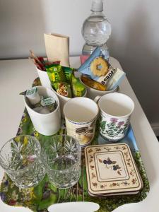 a table with wine glasses and other items on it at Windyridge in Aghagallon