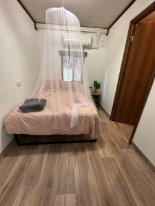 a bedroom with a bed with a mosquito net at 1332 Tally in Upper Tallebudgera