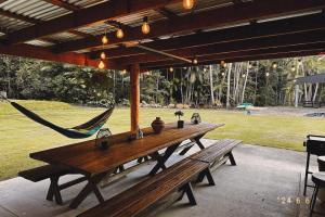a picnic table with a hammock in a park at 1332 Tally in Upper Tallebudgera