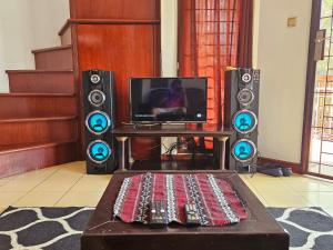a living room with two speakers and a tv at Bella Villa Kota Bunga Puncak in Puncak