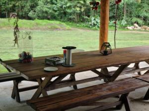 a wooden picnic table in front of a field at 1332 Tally in Upper Tallebudgera