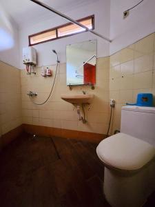 a bathroom with a toilet and a sink at Bella Villa Kota Bunga Puncak in Puncak