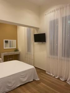 a bedroom with a white bed and a window at Alemar Bed & Breakfast in Mondello +31 photos