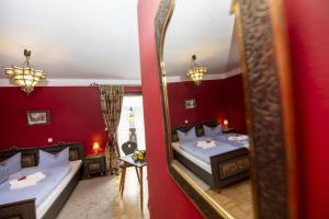 a bedroom with two beds and a mirror at Pension Maria in Antdorf