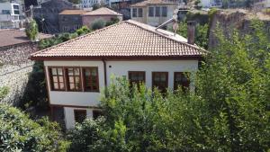 a small white house with a tiled roof at Asiye Hanım Konağı in Trabzon