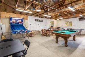 a ping pong room with a pool table and ping pong balls at Hodges Hill Hideout w/ pool, spa, BBQ - Dog Friendly in Oakhurst +57 photos