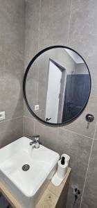 a bathroom with a sink and a mirror on the wall at Vila Luna in Vama Veche