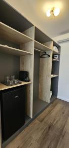 a room with wooden shelves in a room at Vila Luna in Vama Veche