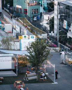an overhead view of a city with people sitting on benches at illi Com Shimokitazawa in Tokyo