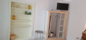 a room with a mirror and a tv on a wall at La casa dell'Ingegnere in Albanella