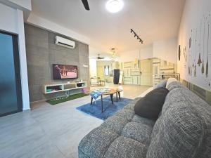 a living room with a couch and a table at New! Tatami 3BR 10-12pax Superb City View I 5mins to Town in Melaka