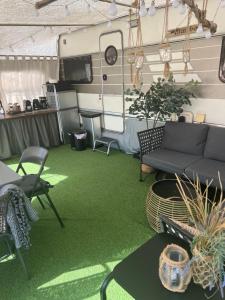a living room with a couch and green carpet at Przyczepa Mumbai in Jastarnia