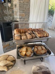 a bunch of different types of bread on a table at Sariza Spring Hotel in Andros