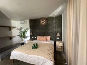 a bedroom with a bed with green shoes on it at Rg real state 3 in Kuta Lombok +30 photos