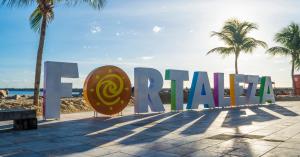 a large sign that says eaton on the beach at Hostel Way Fortaleza in Fortaleza