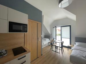 a bedroom with a bed and a table with a chair at Rent Apartment in Wieliczka