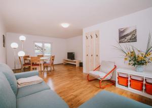 a living room with a couch and a table at NaturparkResort Almmauer in Landl
