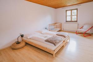 a bedroom with a bed and a chair in it at NaturparkResort Almmauer in Landl