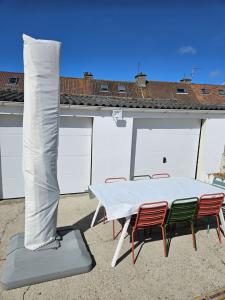a white table and chairs with a tent on a patio at La Sauvagerie in Le Portel