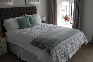 a large bed in a bedroom with a window at Estuary View Bank House Stunning apartment in Millom