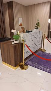 a red ribbon is tied to a counter in a lobby at دار الرياض للشقق المخدومة بالخبر 2 in Al Khobar