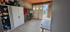 a room with bikes parked on the wall in a garage at Maison proche plage et commerces in Pénestin