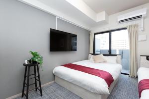 Postel nebo postele na pokoji v ubytování Residence Hotel Hakata Minoshima
