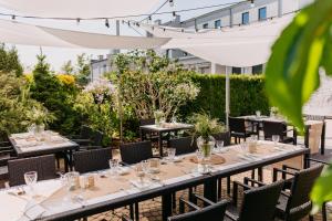a table set up for a dinner party on a patio at Hotel 3 Trio in Białystok