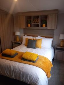 a bedroom with a large bed with pillows on it at Nadia's Lodge Smart TV & Wi-Fi in Haverigg