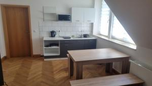 a small kitchen with a table and a sink at Rot Monteurzimmer in Paderborn