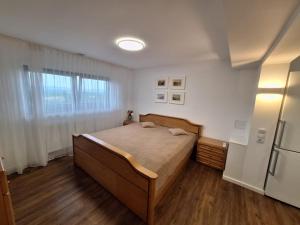 a bedroom with a bed and a refrigerator at Grünes Studio in Hameln
