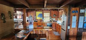 a kitchen with wooden cabinets and a white refrigerator at House 53 Sodwana Bay Lodge in Sodwana Bay