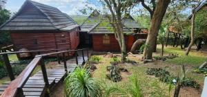 a wooden cabin with a wooden walkway leading to it at House 53 Sodwana Bay Lodge in Sodwana Bay