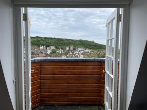 an open door to a balcony with a view at Croft House Hastings in Hastings +32 photos